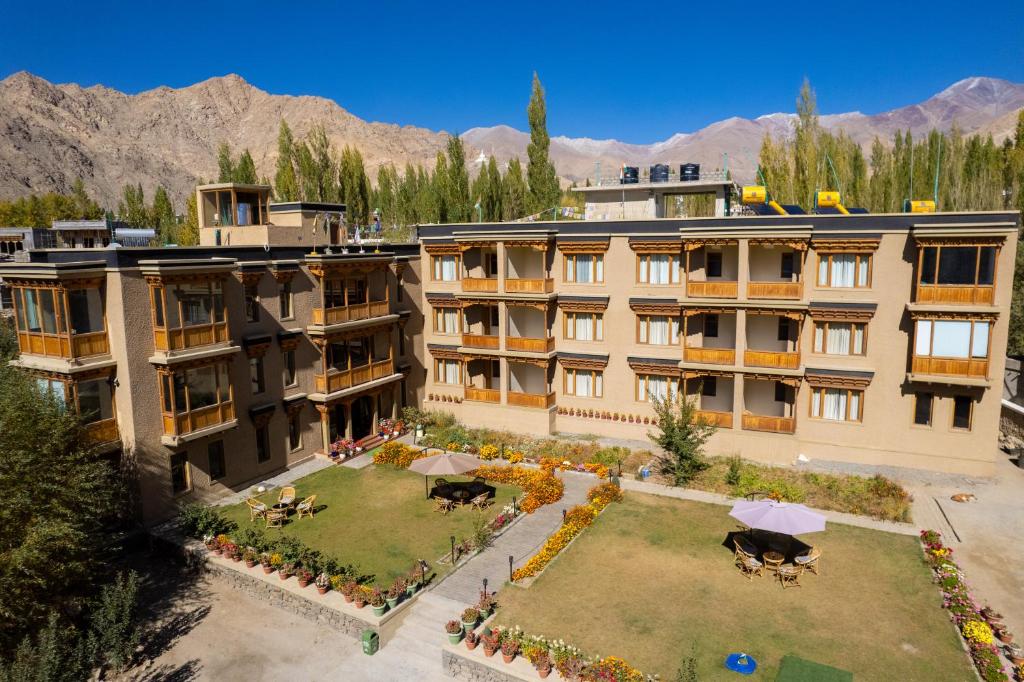 Front view of The Saraha in Leh Ladakh, one of the best reasonable hotels with a scenic garden, mountain backdrop, and budget-friendly comfort.